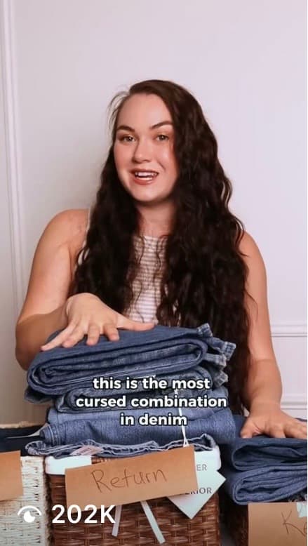 Video thumbnail: a woman behind a stack of folded jeans, captioned “this is the most cursed combination in denim”, 202K views